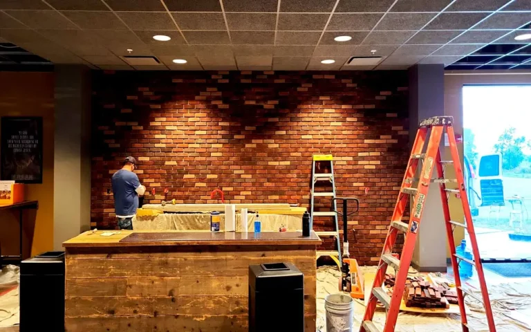 Mason installing interior thin brick