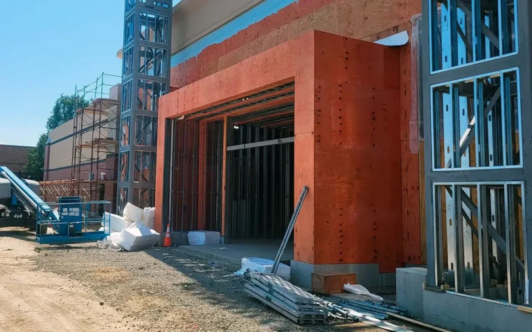 Industrial warehouse facade work: brick wainscot installation