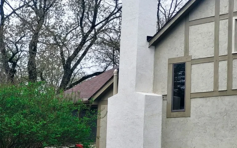 Exterior stucco chimney stack finish on a farmhouse