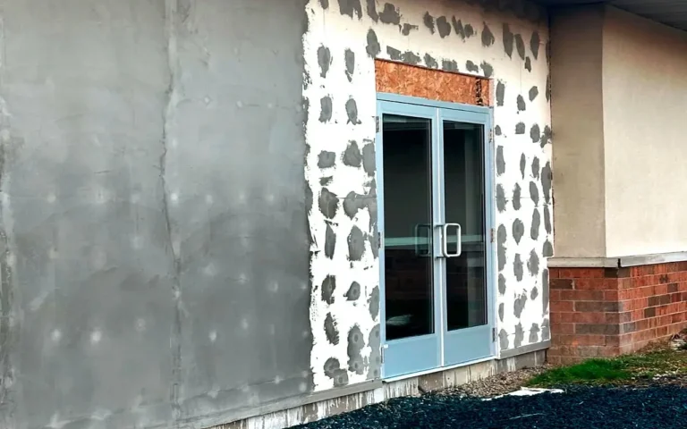 Professional stucco remediation on a residential home exterior wall in Ohio, restoring the building envelope.